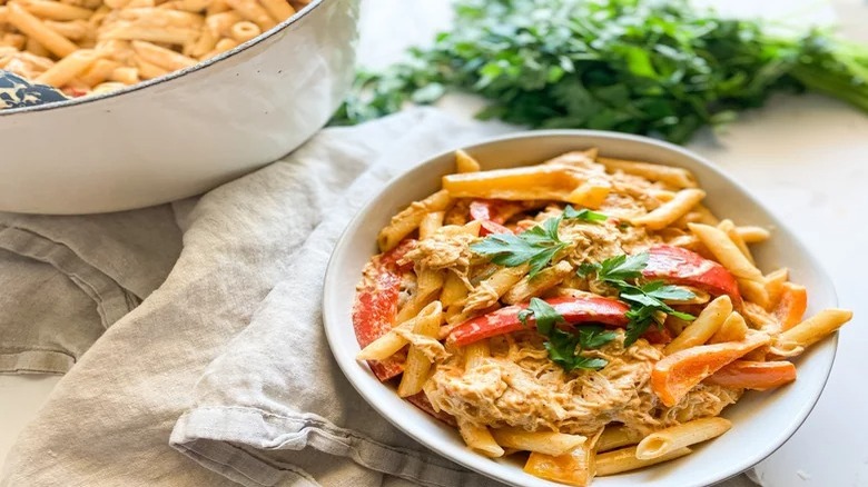 bowl of creamy jerk rasta pasta with garnish