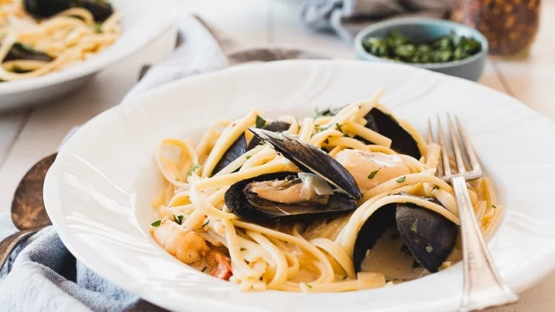 bowl of creamy seafood pasta with fork