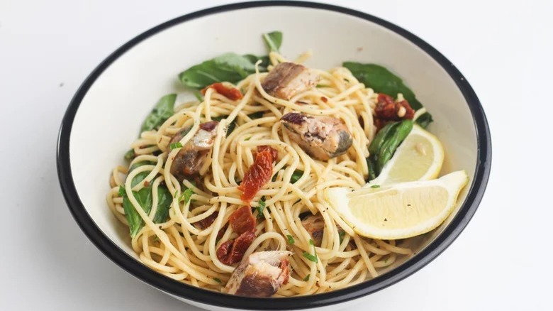 bowl of sardine pasta with lemon slices