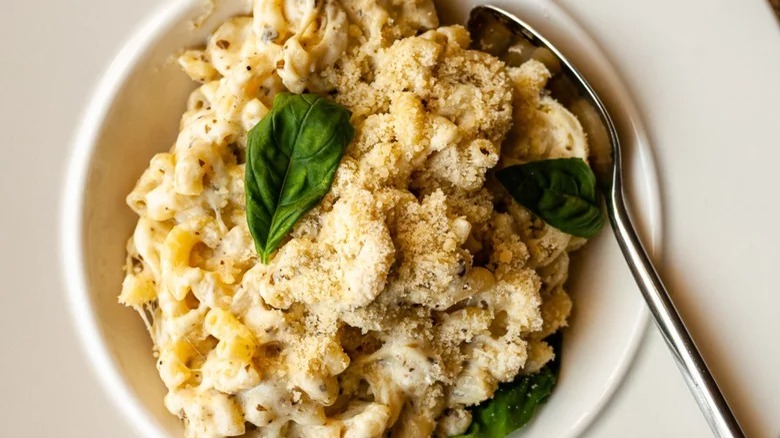 bowl of pesto mac and cheese with spoon