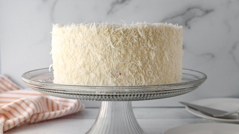 coconut cake on pedestal