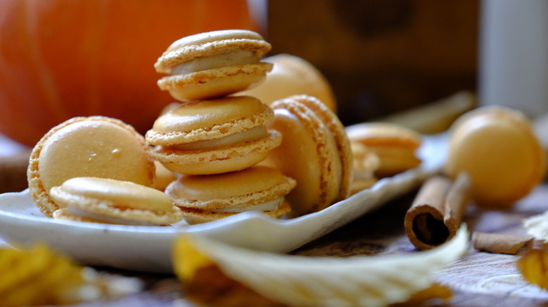 pumpkin macarons with cinnamon stick