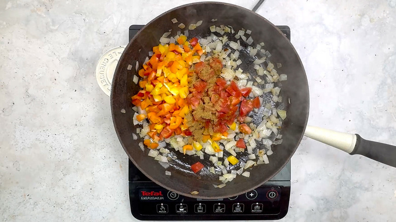  bell pepper, tomato, and cumin in pan