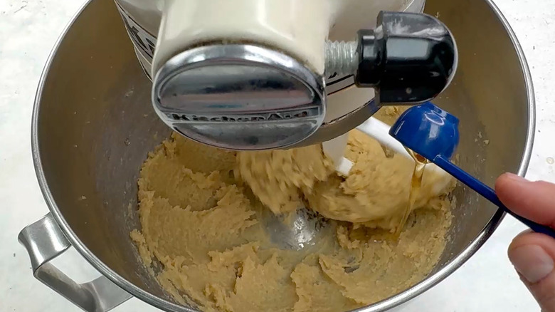 adding vanilla to butter and sugar