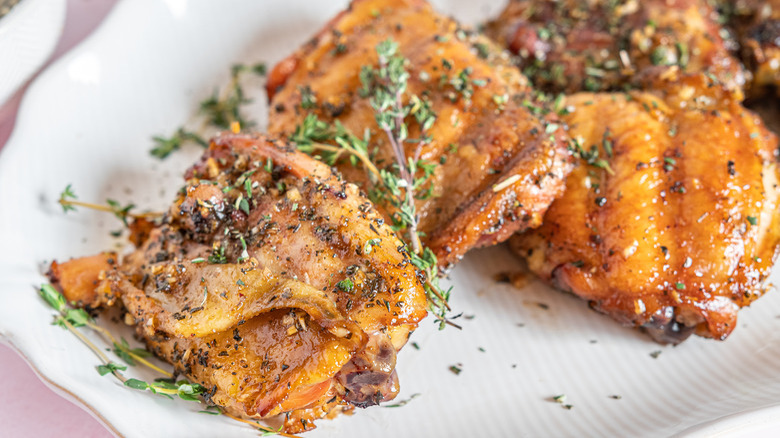 chicken thighs with thyme garnish