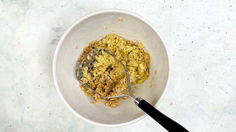 mashed chickpeas and avocados in bowl