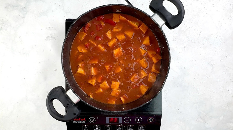 sweet potato cooking in tomato sauce