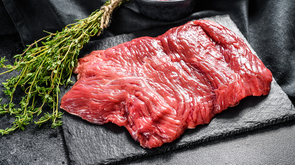 Raw skirt steak and herbs