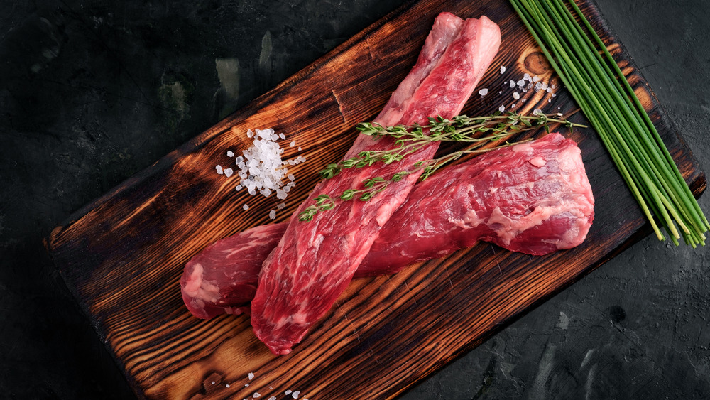 Raw beef tenderloin on a wooden board