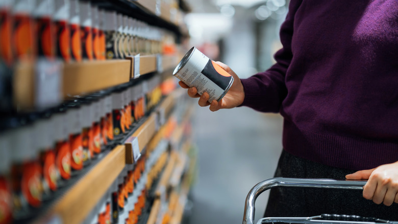 woman shopping canned food