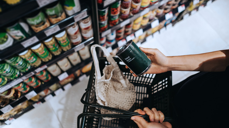 woman shopping canned food