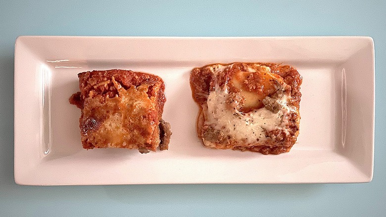 Eggplant Parmesan and lasagna on elongated white plate with blue background