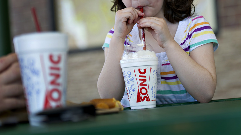 Person sipping sonic Milkshake