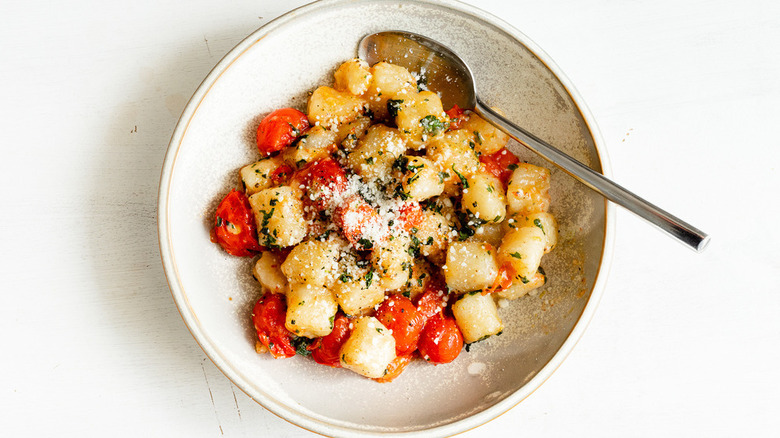 Gnocchi and tomatoes in bowl