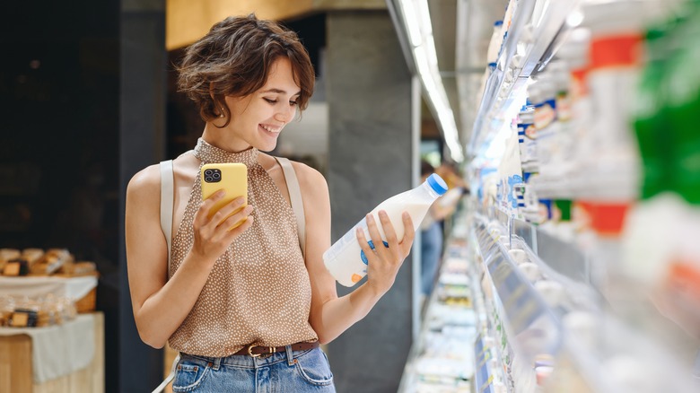 Woman looking at milk