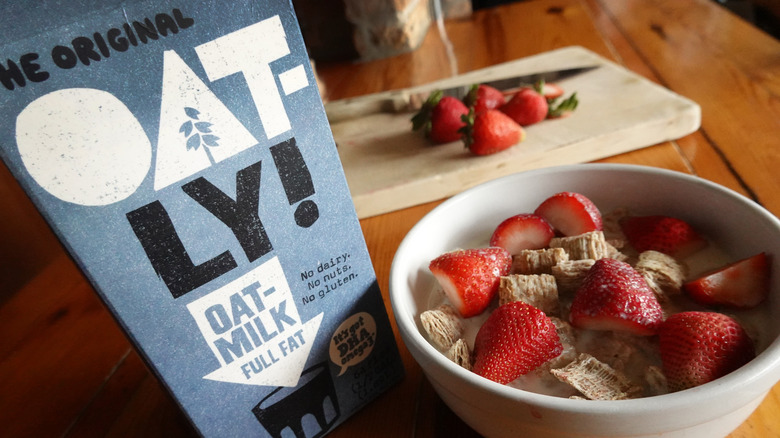 Oatly milk by cereal and strawberries