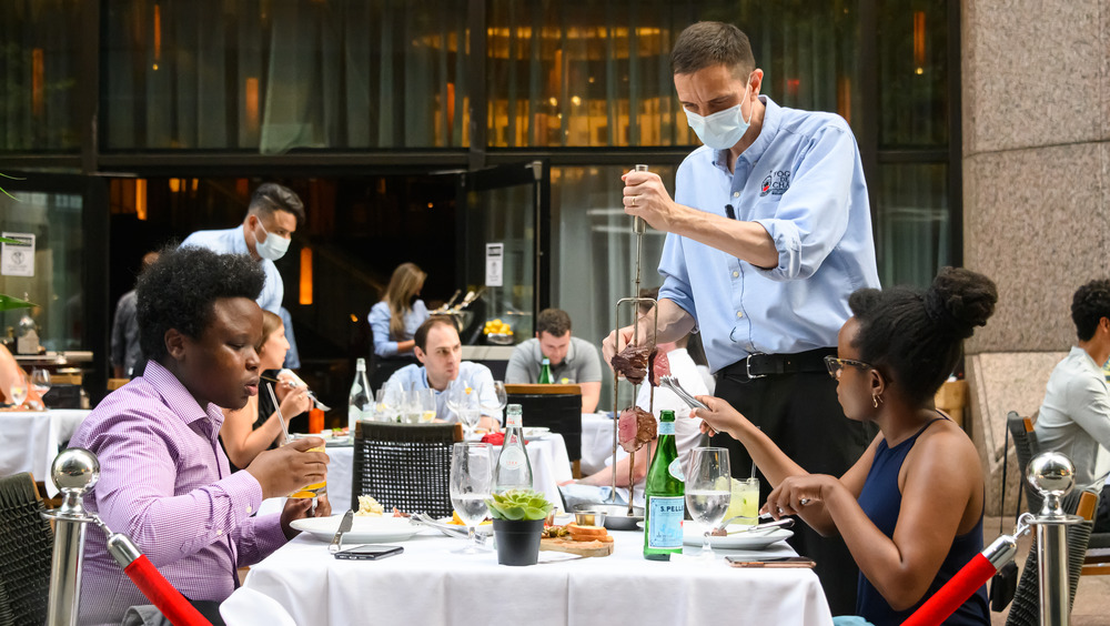 People dining out at a Brazilian steakhouse