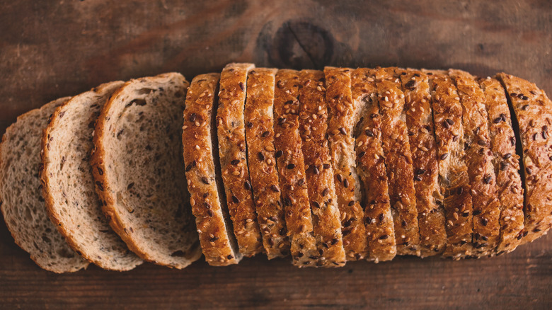 Sliced sprouted bread on cutting board