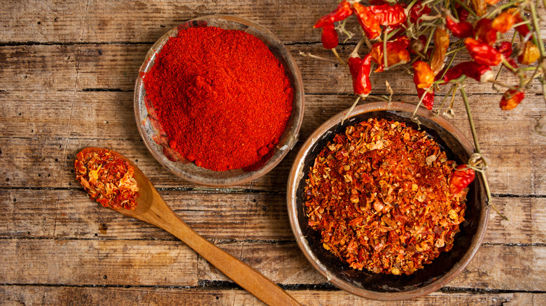 Ground peppers and paprika in bowls