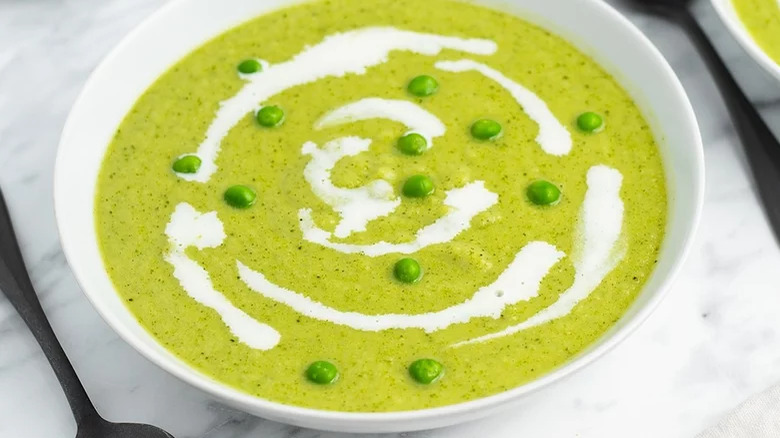 bowl of pea and broccoli soup with spoons