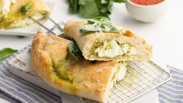 sliced pesto calzone with garnish