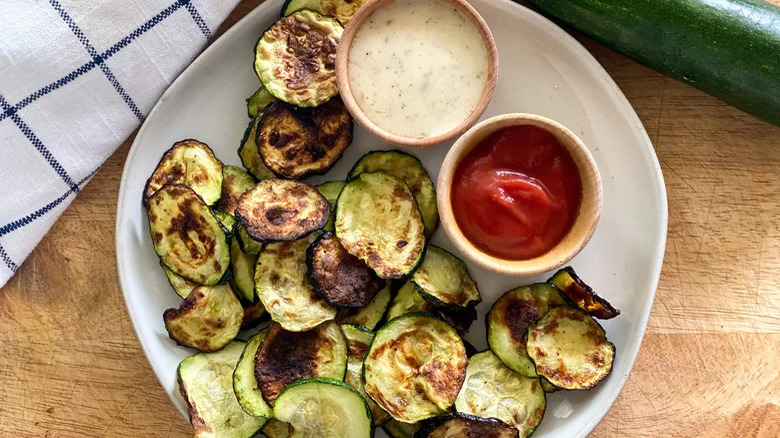 plate of air fried zucchini chips with sauces on side