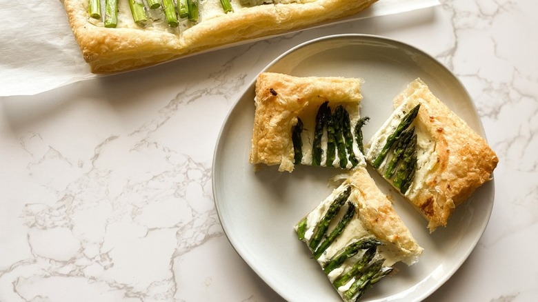 asparagus tart cut into squares on plate