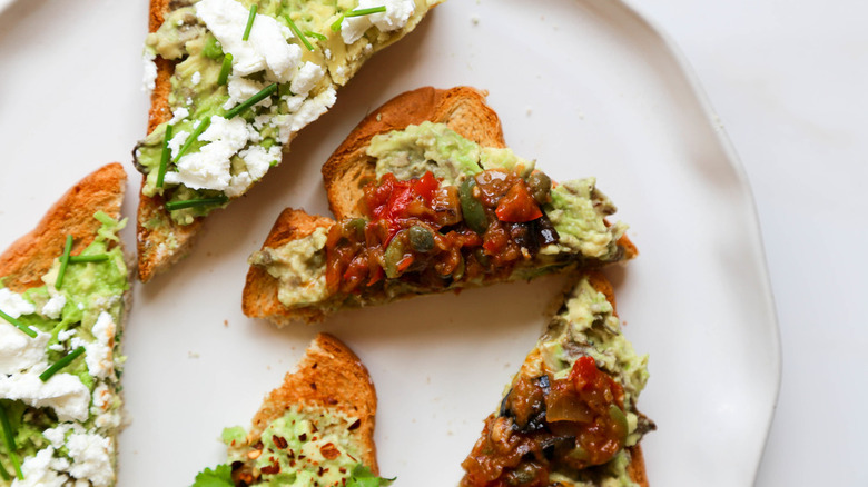 triangles of avocado toast with various garnishes