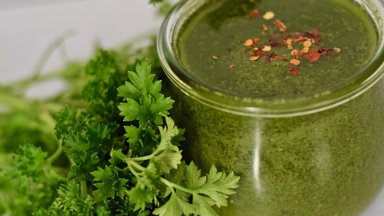 ramekin of chimichurri sauce with parsley on side