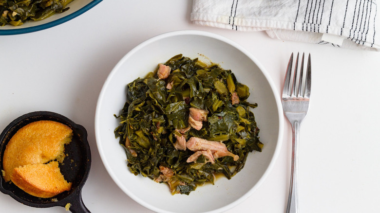 bowl of collard greens fork cornbread on side