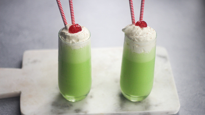 glasses of Copycat McDonald's Shamrock Shake with straws and cherries