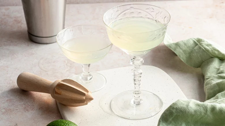 glasses of green ghost cocktail with wooden muddler