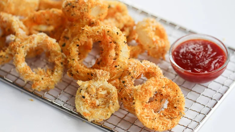 Onion rings on a rack with a dip