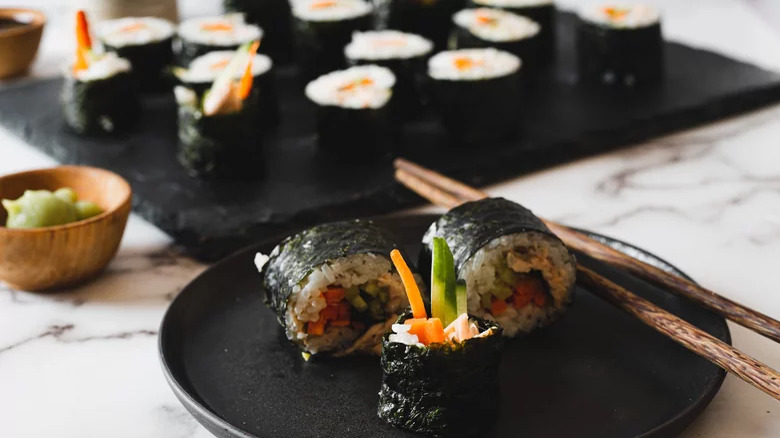 sushi on plate with chopsticks