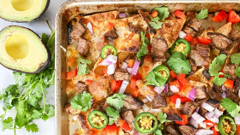 nachos in pan with toppings