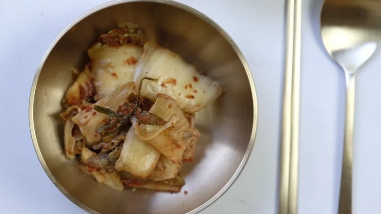 kimchi with chopsticks and spoon