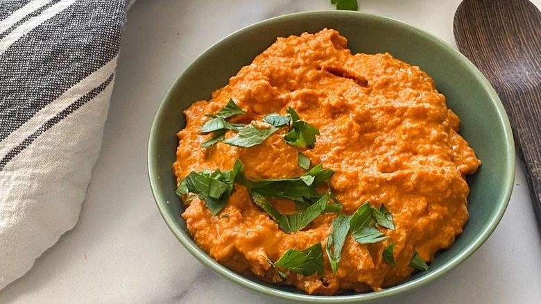 bowl of muhammara with garnish