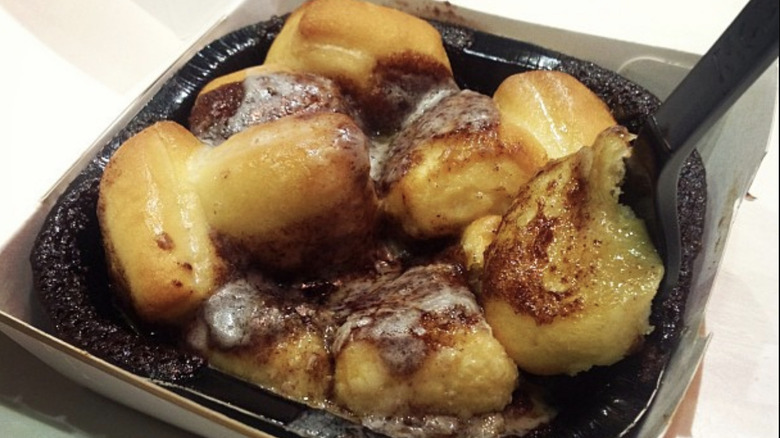 Pile of cinnamon dough bites topped in cream cheese icing