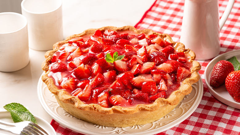 strawberry pie with gelatin on checkered tablecloth