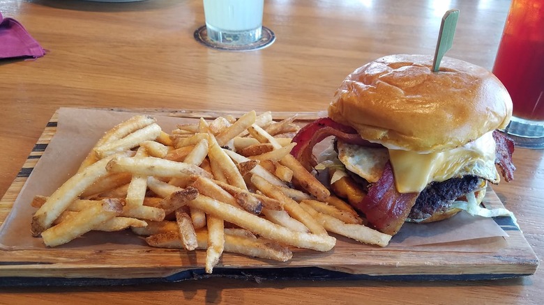 cheeseburger with fries wooden table