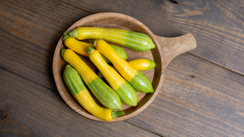 zephyr squash in a wood bowl