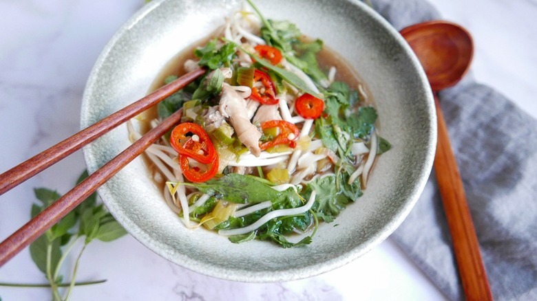 pho in bowl with chopsticks