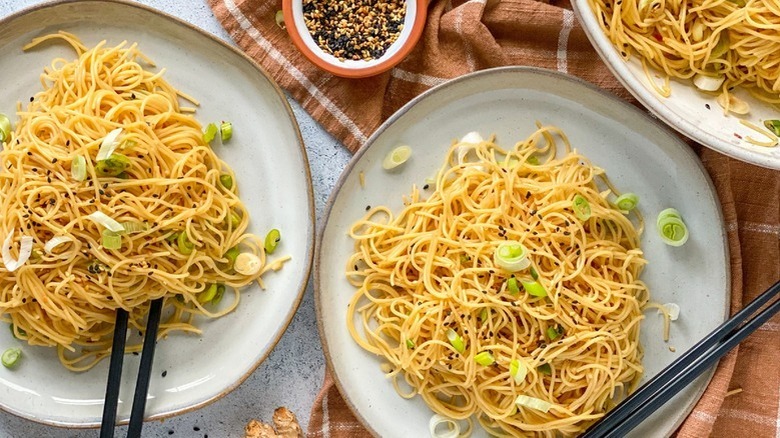 noodles with scallions on plates