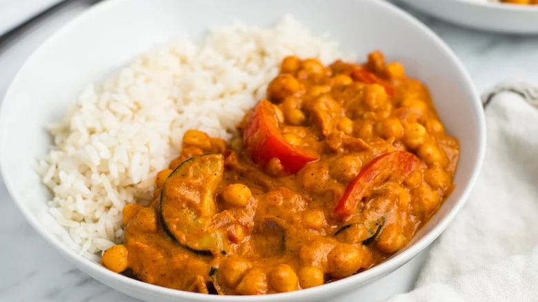 bowl of chickpea vegetable curry with white rice