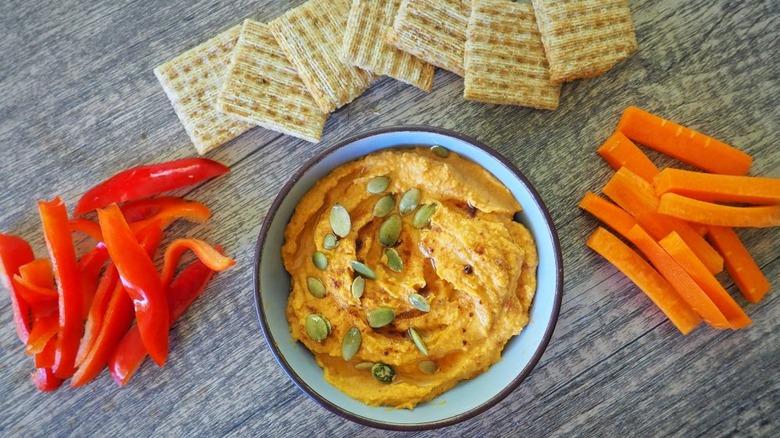 3-ingredient pumpkin hummus with crackers peppers carrots