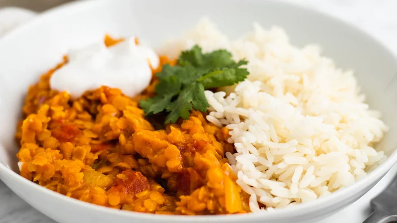 bowl of coconut red lentil dal with white rice