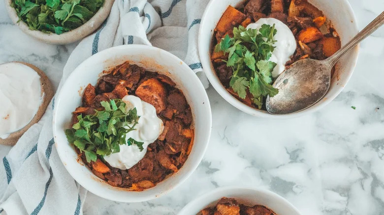 bowls of vegetarian mushroom goulash with spoon