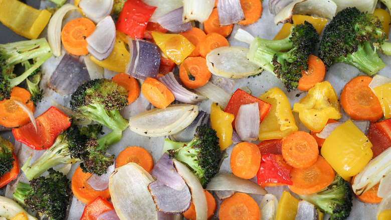 spread of roasted vegetables peppers carrots broccoli onion