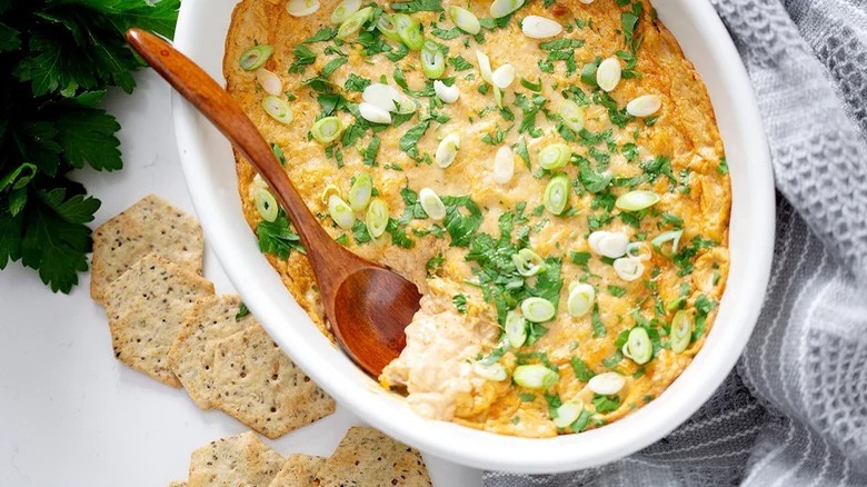 clam dip with wooden spoon