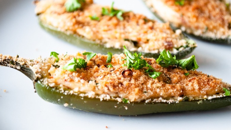 close up of jalapeno popper with breadcrumbs and garnish